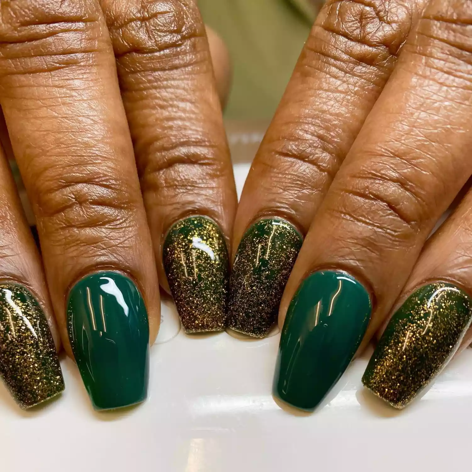 green and gold manicure glossy nail design